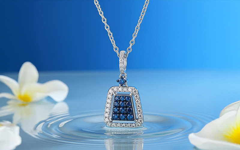 Creative Jewelry Photographer V1 example — sapphire pendant in a clean lifestyle water scene