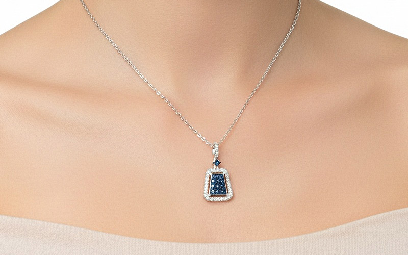 Necklace Try-On Studio example — model wearing a fine sapphire pendant with realistic chain draping