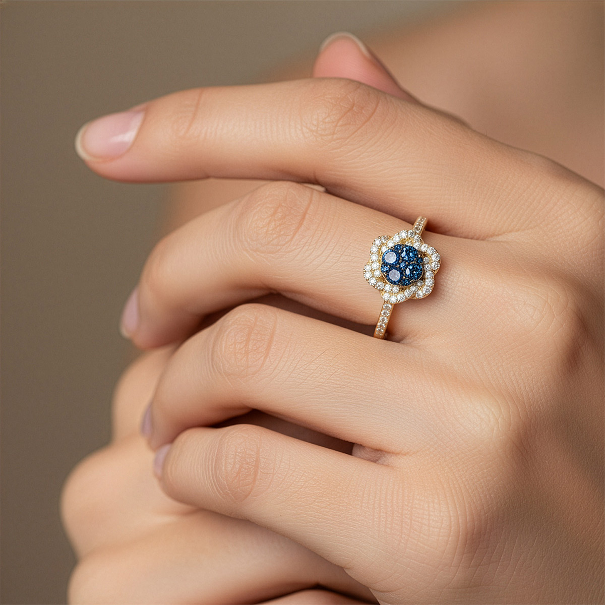 The same blue diamond ring on an AI-generated model's hand after jewelry virtual try-on
